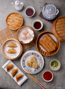  A Chinese dish of small steamed or fried savory dumplings containing various fillings, served as a snack or main course.
