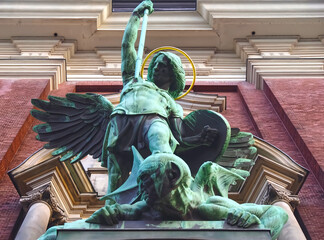 Fototapeta na wymiar Sculpture of Archangel Michael fighting Satan at St. Michaelis Church in Hamburg