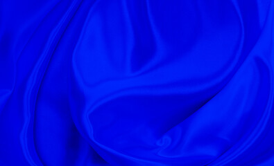 Black blue satin dark fabric texture luxurious shiny that is abstract silk cloth background with patterns soft waves blur beautiful.