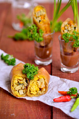 An Indonesian traditional snacks loempia or lumpia eaten with brown sauce, chili and onion  isolated on wood table
