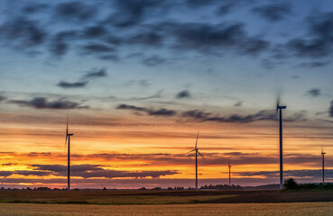 Naklejka na ściany i meble Windmill in Nature. Blurry Cloudy Sky. Long Exposure. Beautiful Nature. Sunset Light.