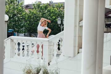 a woman dancing on the stairs on the street alone © dmitriisimakov