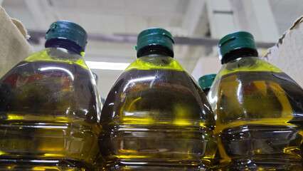 Green bottles in the store with lids and oil liquid for background, texture, pattern
