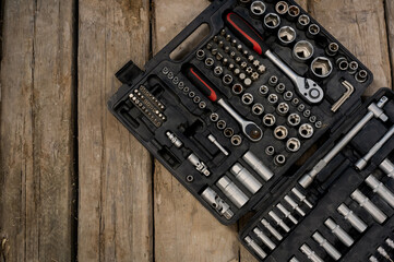 Set of wrenches and bits. Tools box. Tools kit. Wooden board.