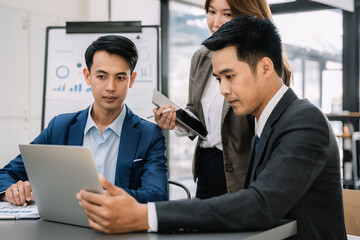Group of Young Asian business team creative businesspeople coworker in office. Meeting Presentation for analysis graph company financial. People Work in Business Office.