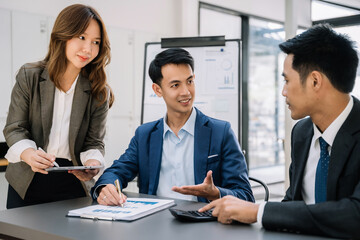 Fototapeta premium Group of Young Asian business team creative businesspeople coworker in office. Meeting Presentation for analysis graph company financial. People Work in Business Office.