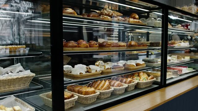 Counter full of delicious buns and pastries in a shop bakery