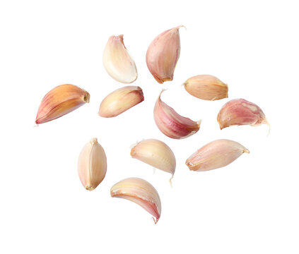 A collection of garlic cloves isolated on a flat background.