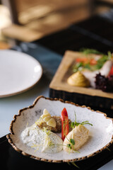 Curd spread served with a sprig of fir tree, parsley and an edible flower
