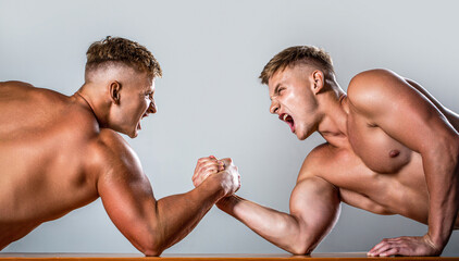 Arm wrestling. Two men arm wrestling. Rivalry, closeup of male arm wrestling. Two hands. Men...