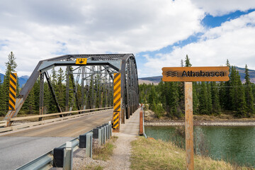 H. J. Moberly Bridge. Athabasca River under blue sky and white clouds, Jasper National Park, Alberta, Canada.