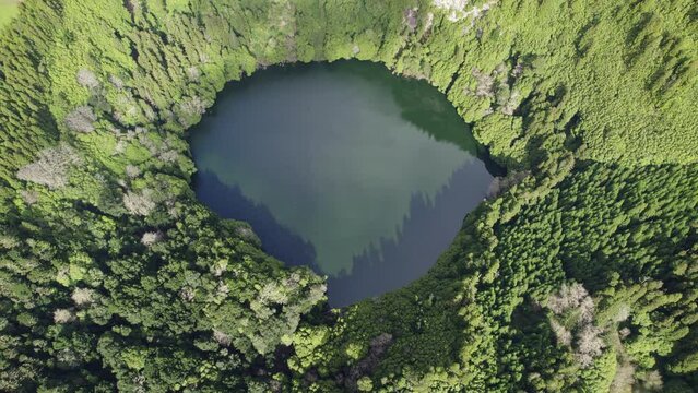 Drone Slowly Going Up Over Round Green Lake Forest In Lagoa Do Congro Azores