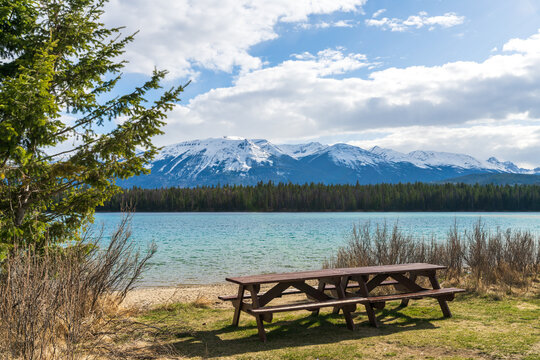 Lake Annette lake shore beach and bench, Jasper National Park stunning nature scenery in summer time. Landscape of Canadian Rockies, Alberta, Canada.