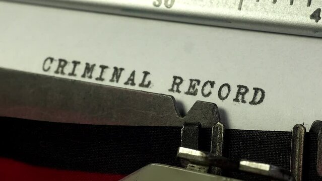 Crime and law and order. Using an old manual typewriter to type up a Criminal Record.