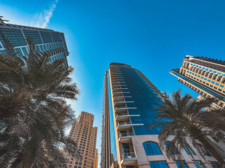Obraz premium Dubai Marina, harbour, cruise boat and canal promenade view at sunset, in Dubai, United Arab Emirates