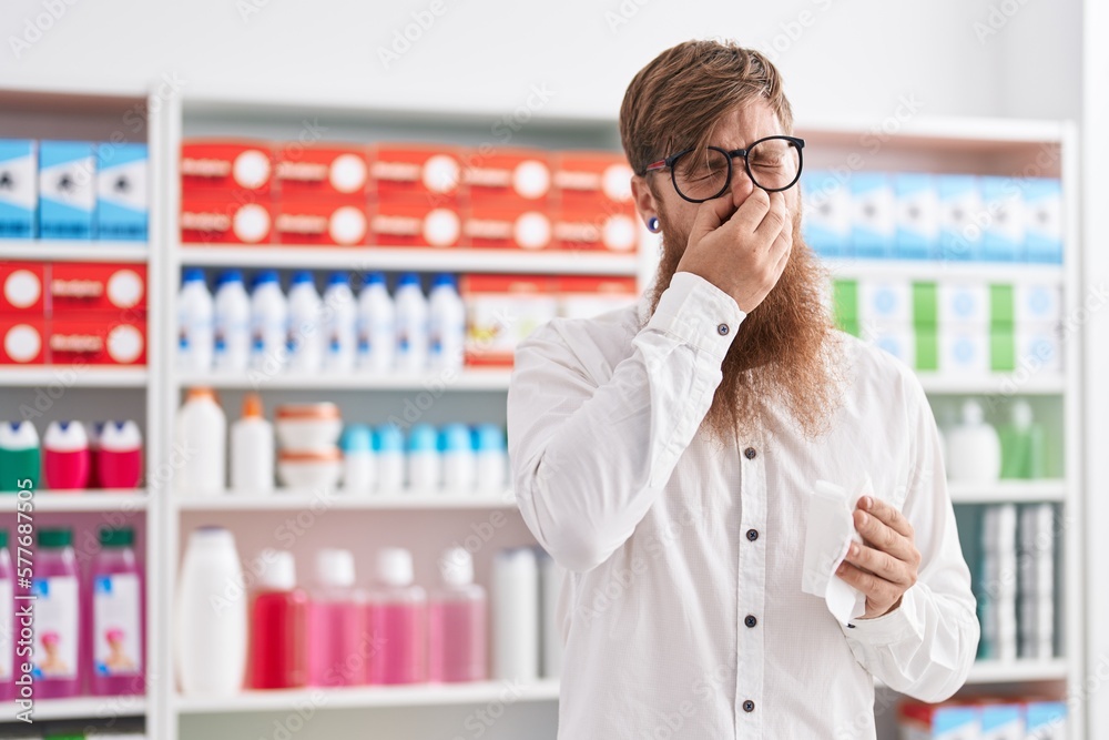 Canvas Prints Young redhead man customer using nakpin at pharmacy