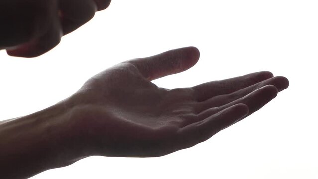 man sprays disinfectant on his palm on a white background. antiseptic. close-up.