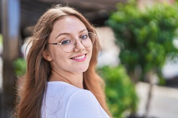 Young blonde woman smiling confident standing at street