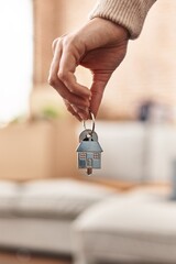 Young woman holding key of new house at new home