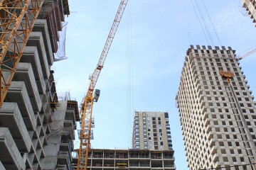 Crane and building construction site. Industry modern new civil house business. Concept of development improvement town. Architecture planning of a city. Renovation project. Residential area