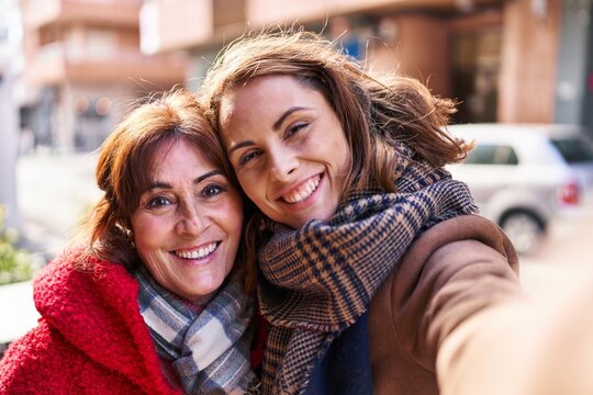Two women mother and daughter make selfie by camera at street - Powered by Adobe
