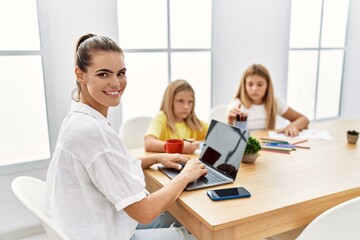 Mother and daughters smiling confident working and drawing at office
