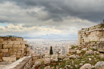 View on Athens from Pantheon on winter during cloudy cold day with snow on the mountain in...
