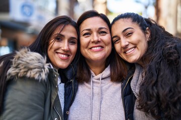 Three woman mother and daughters standing together at street