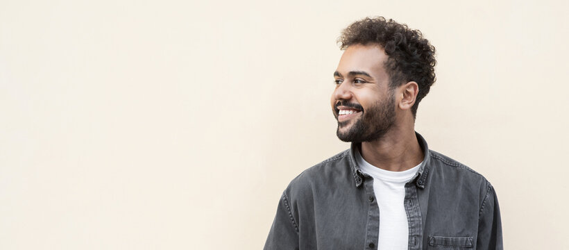 Closeup portrait of handsome smiling young man. Laughing joyful cheerful men isolated studio shot. Panoramic banner