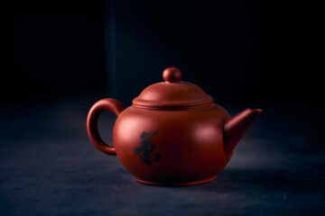 Volumetric photo of a Chinese teapot for brewing tea on a black background