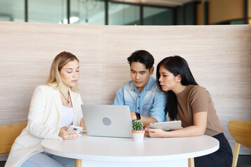 Full concentration at work. Multi-ethnic business people with serious faces are sitting in the office and discussing solutions. Concept of teamwork and best collaboration