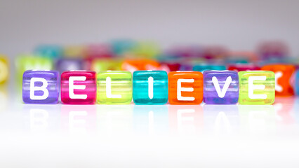 believe word in colorful blocks. words in colorful cubes. fun concept about trust. inscription on the cubes