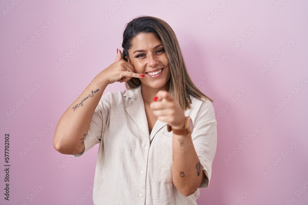 Canvas Prints blonde woman standing over pink background smiling doing talking on the telephone gesture and pointi