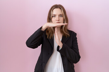 Young caucasian business woman wearing black jacket doing time out gesture with hands, frustrated...
