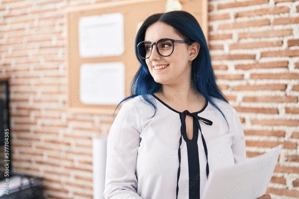 Wall mural Young caucasian woman business worker reading document at office