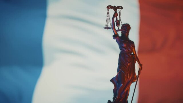The Statue of Justice - lady justice, Justitia the Roman goddess of Justice in front of French flag
