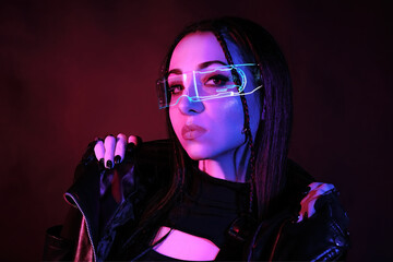 Model in neon glasses in cyberpunk style portrait with dreadlocks in a black jacket