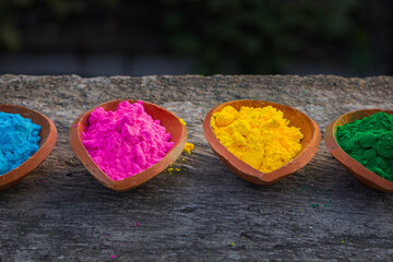 Obraz na płótnie Canvas happy holi. gullal or abir, which are colorful powders for holi kept on clay pots or lamps on occasion of indian festival of colors. holi or dolyatra is festival of colors in india.