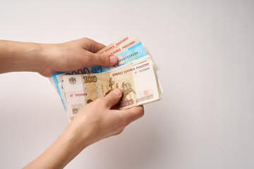 Hands counting Russian money bills, close-up