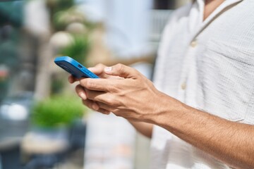 Young arab man using smartphone at street