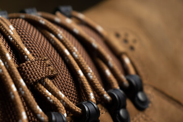 Close up shoelace on leather shoe. Brown shoe detail background. Thread sew pattern. Fashion