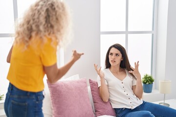 Two women mother and daughter arguing at bedroom