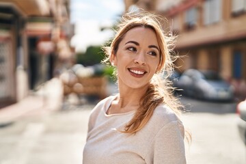 Young woman smiling confident looking to the side at street