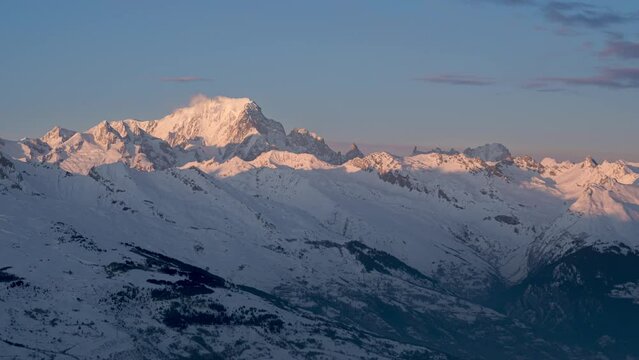 Day to night transition time lapse of snowy Alps and view of Mont Blanc. Aerial and zoom in view