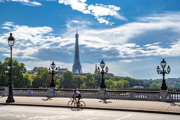 Bridge Pont Alexandre III  Over River Seine With Single Bicycle Rider And View To Eiffel Tower In Paris, France