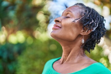 Middle age african american woman smiling confident breathing at park