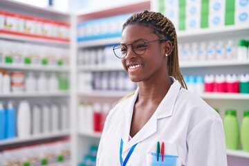 African american woman pharmacist smiling confident standing at pharmacy