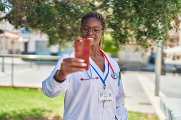 Fototapeta premium African american woman doctor smiling confident having video call at park