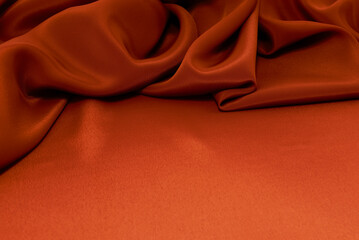 texture of crumpled fabric of red or orange color. Canvas. Textile. Material chintz or satin