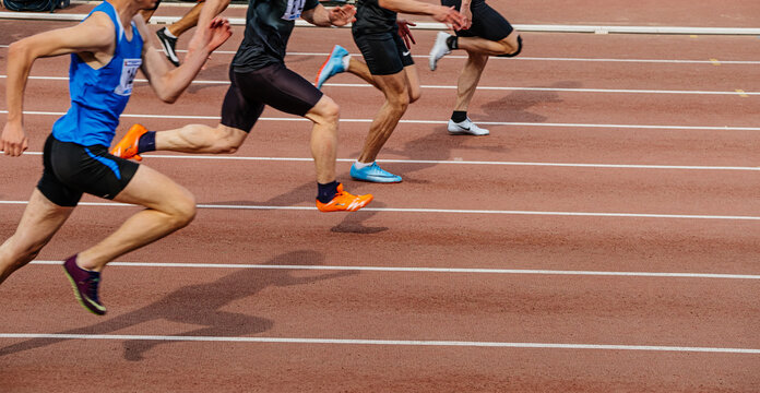 Chelyabinsk, Russia - June 4, 2022: group male athlete running sprint race in spikes shoes Nike during UFD Athletics Championship